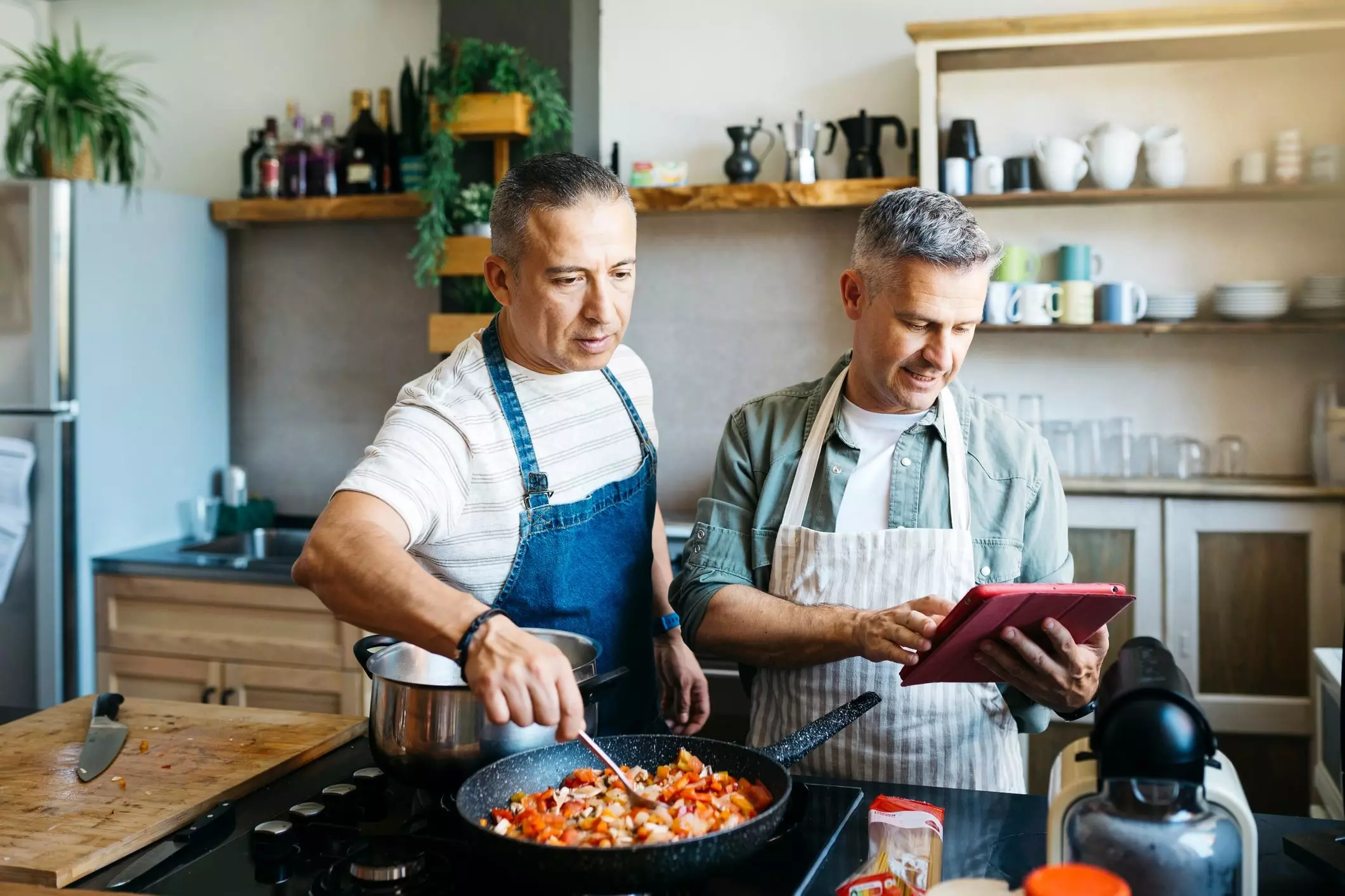 Gay couple cooking in a kitchen