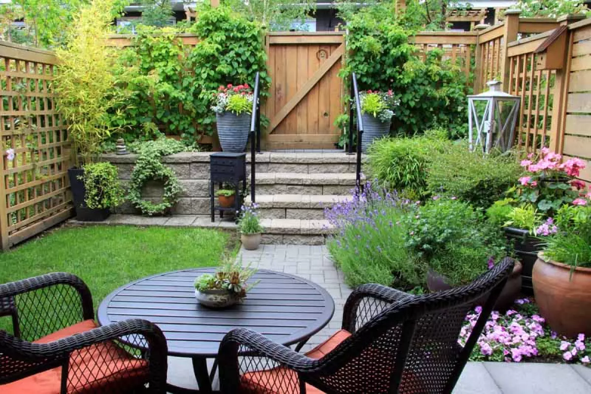 A seating arrangement in the small back garden of a townhouse.