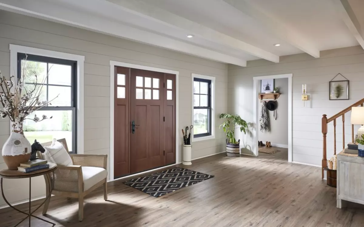 Rustic-modern foyer with double hung windows and wood entry door