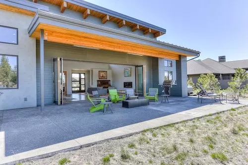 Partially covered patio off the open-plan Great Room in a mid-century style home