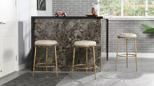 Pictured Above: Aerin Hammered Brass Backless Round Bar Stool and Counter Stool