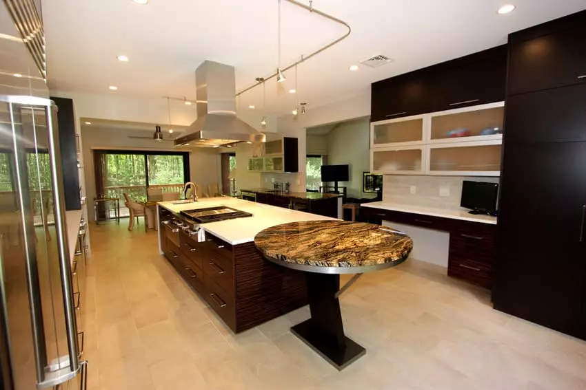 Open plan layout kitchen with laminated pinewood cabinets and black ceramic flooring