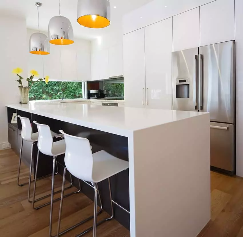 Kitchen with aqua backsplash and white solid surface counter