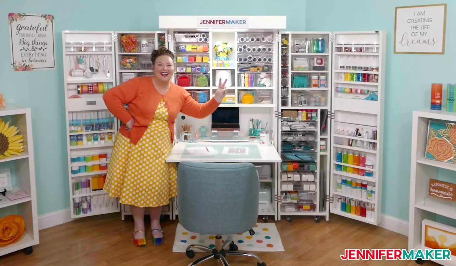 Jennifer Maker standing happily in front of her closed DreamBox 2 craft storage furniture.