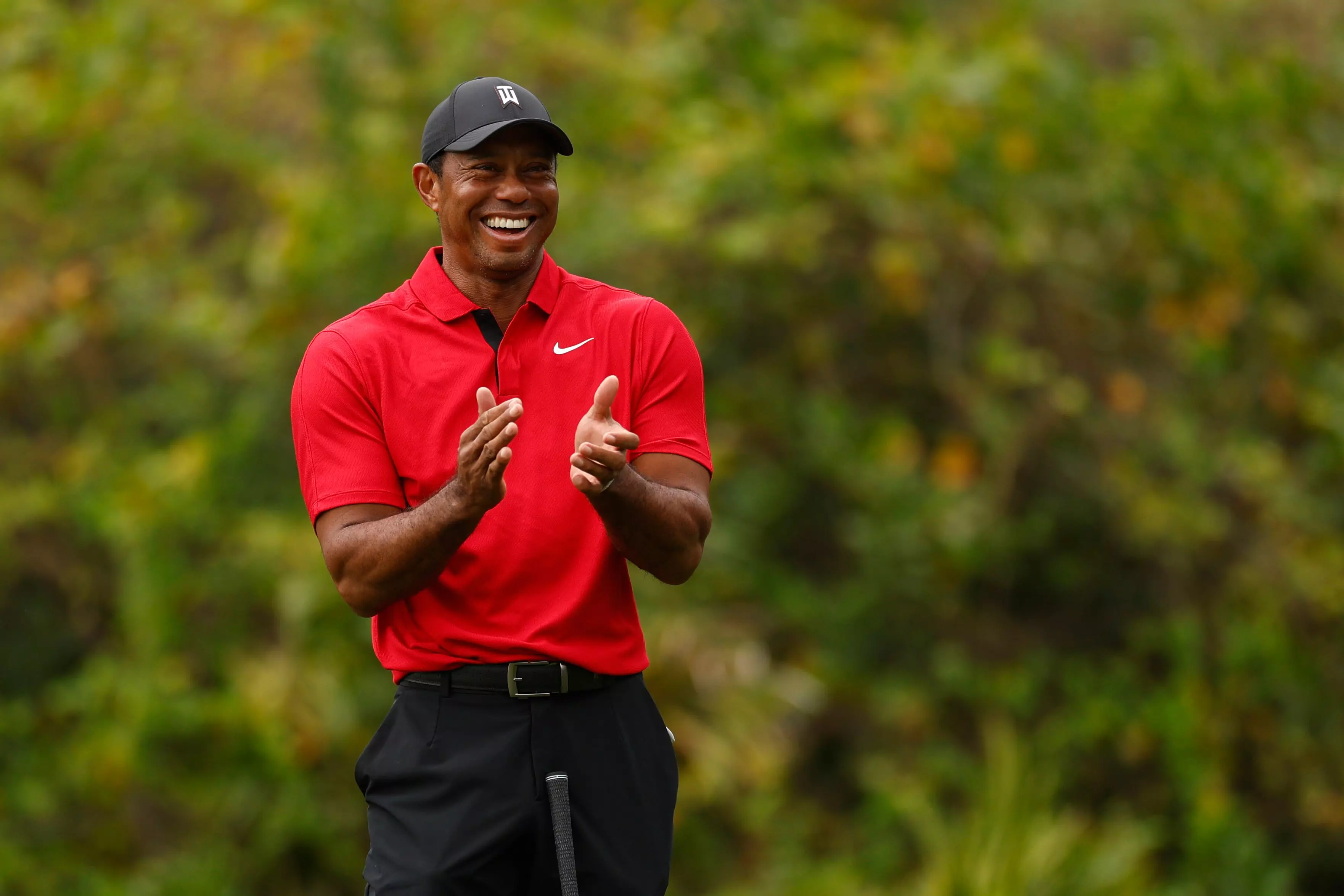 Tiger Woods reacts after his son, Charlie Woods, chips in for a birdie on the ninth green during the final round of the 2023 PNC Championship at the Ritz-Carlton Golf Club in Orlando. (Photo by Mike Ehrmann/Getty Images)