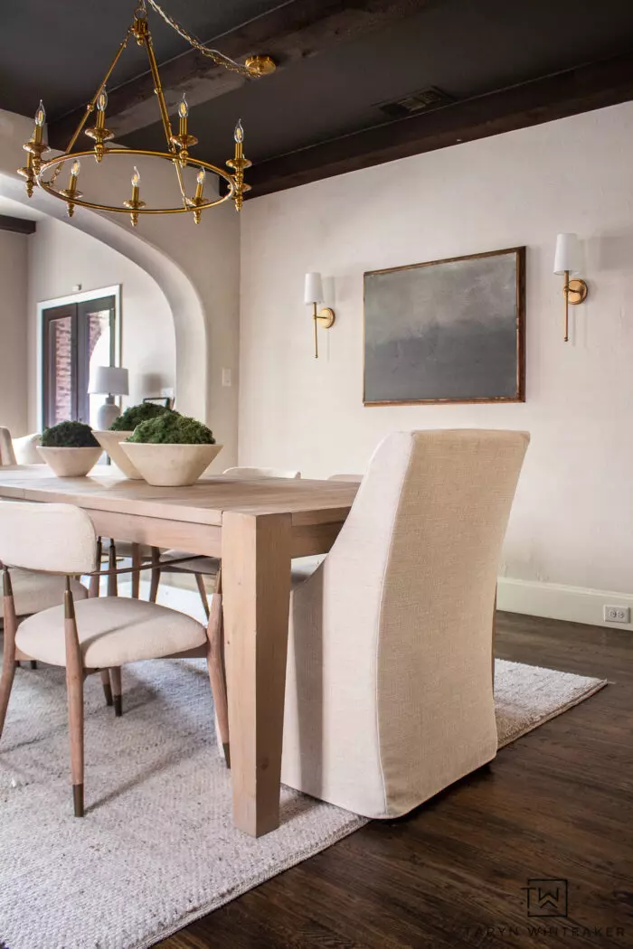 Tour this Modern Transitional Dining Room that features soft neutral textures and gold accents, combining cozy and elegant design.