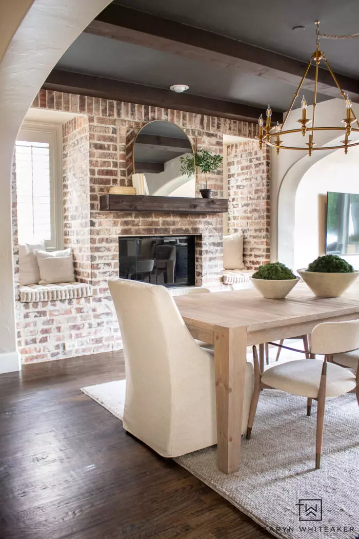 Tour this Modern Transitional Dining Room that features soft neutral textures and gold accents, combining cozy and elegant design.