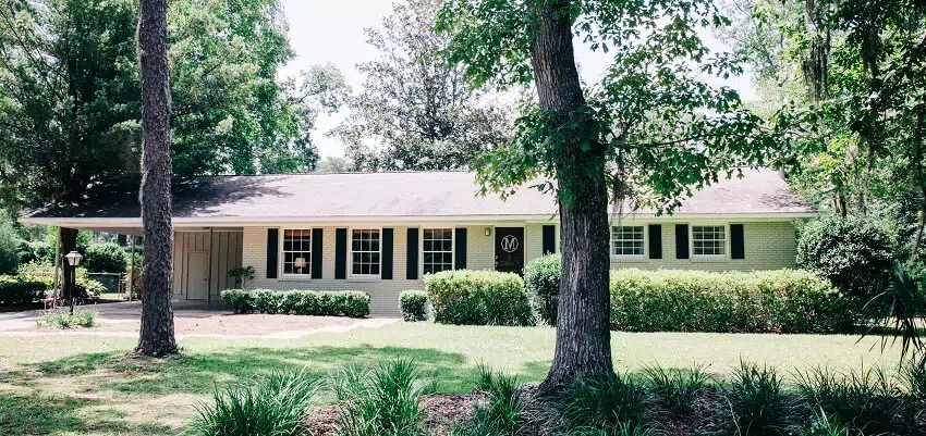 One level ranch house exterior with garage and concrete walkway