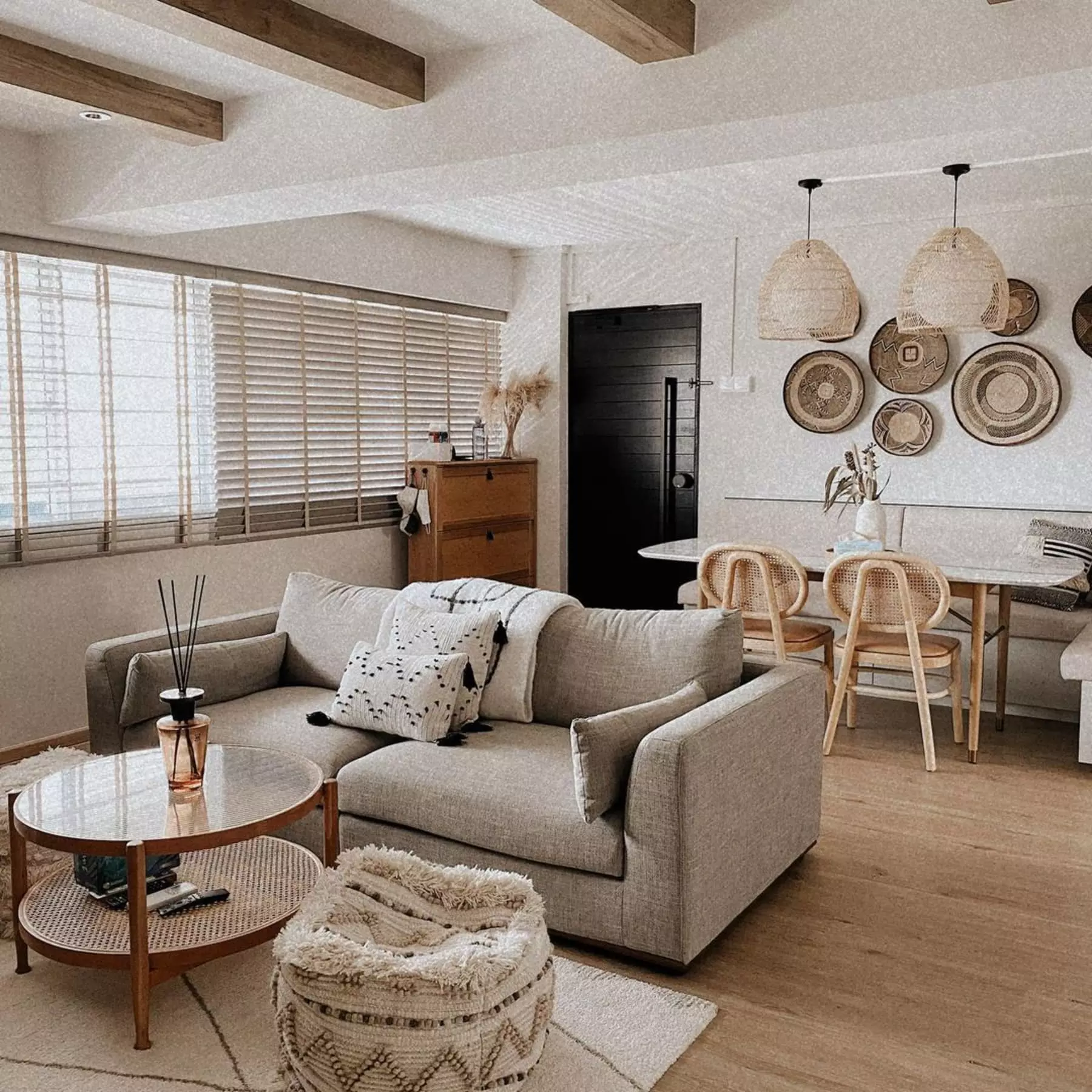 A living room with a gray sofa, coffee table, and ottoman.