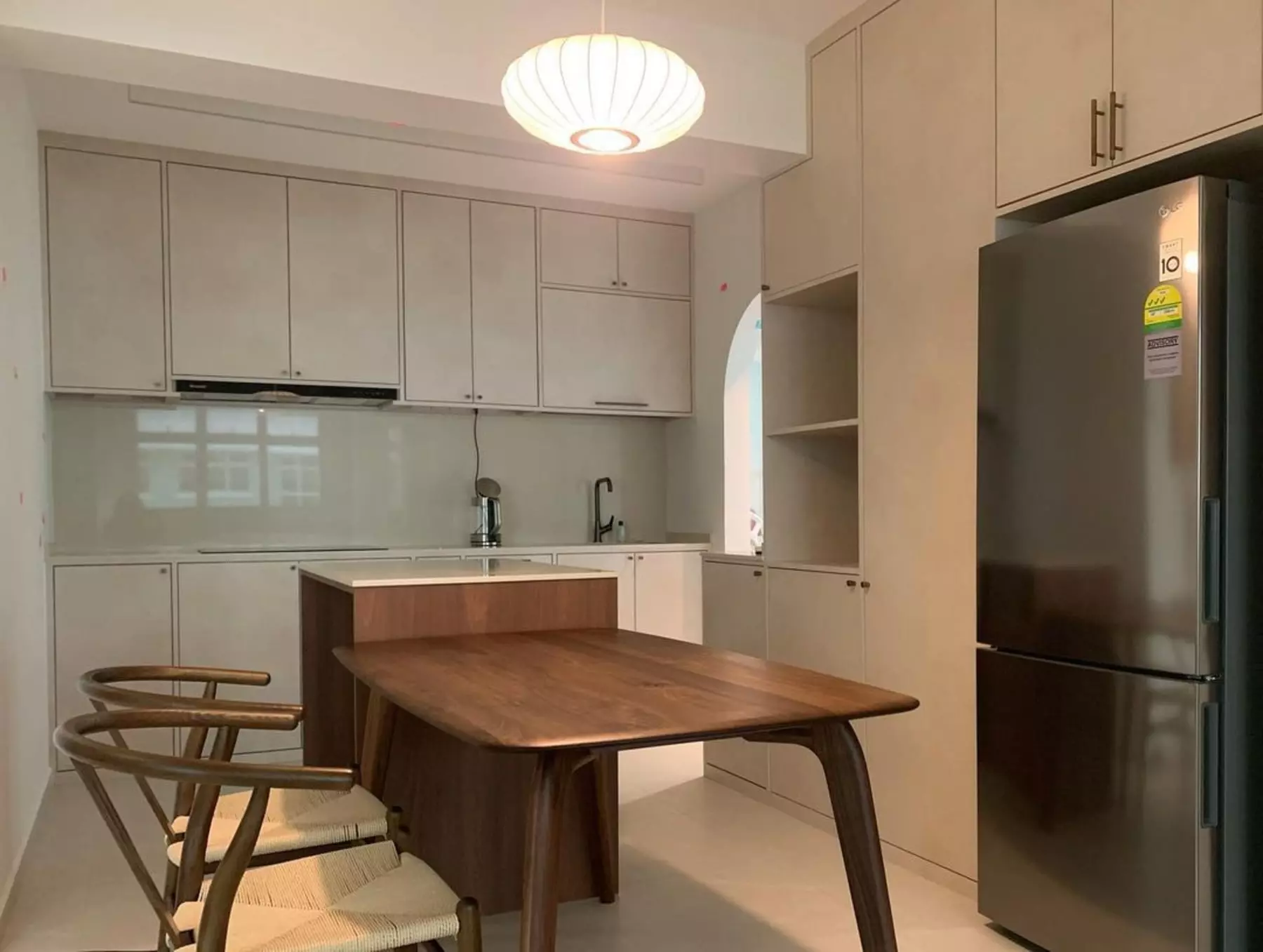 An open-concept kitchen with a walnut wood dining table.