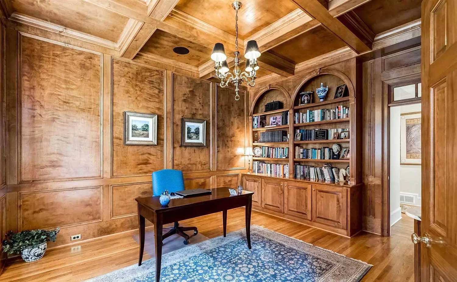 Beautiful wood wall design with medium brown stain. Lighter wood floors with a yellow tint.