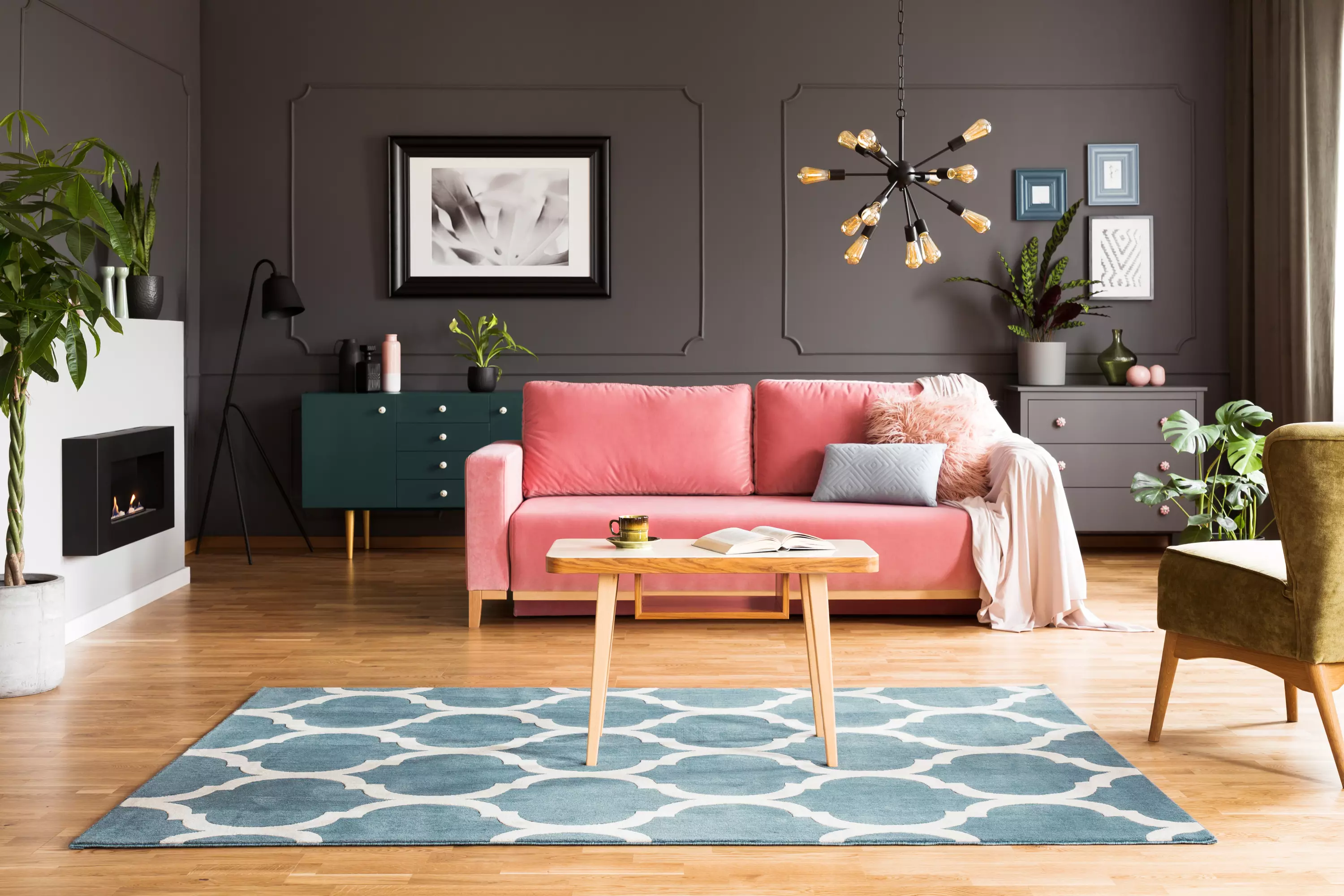 Gray living room with pink sofa and blue rug