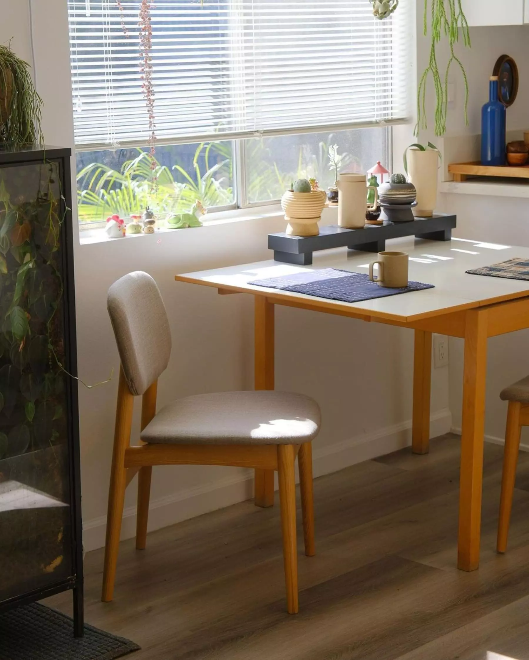 A wooden dining chair with a matching dining table.