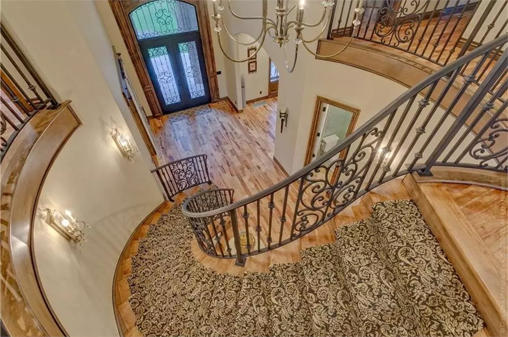 Grand, curving staircase in the foyer of a large home