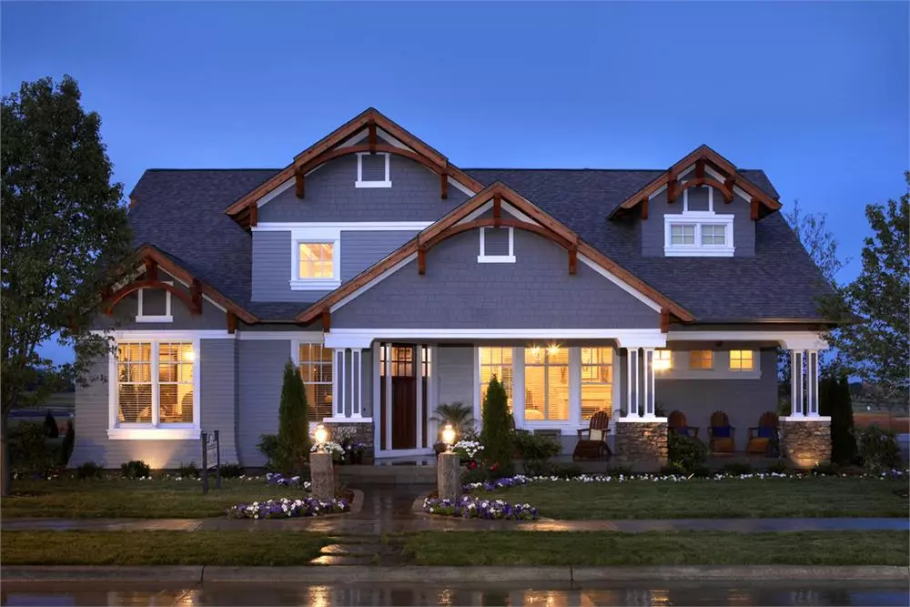 Craftsman style home with slate-blue siding and natural wood accents