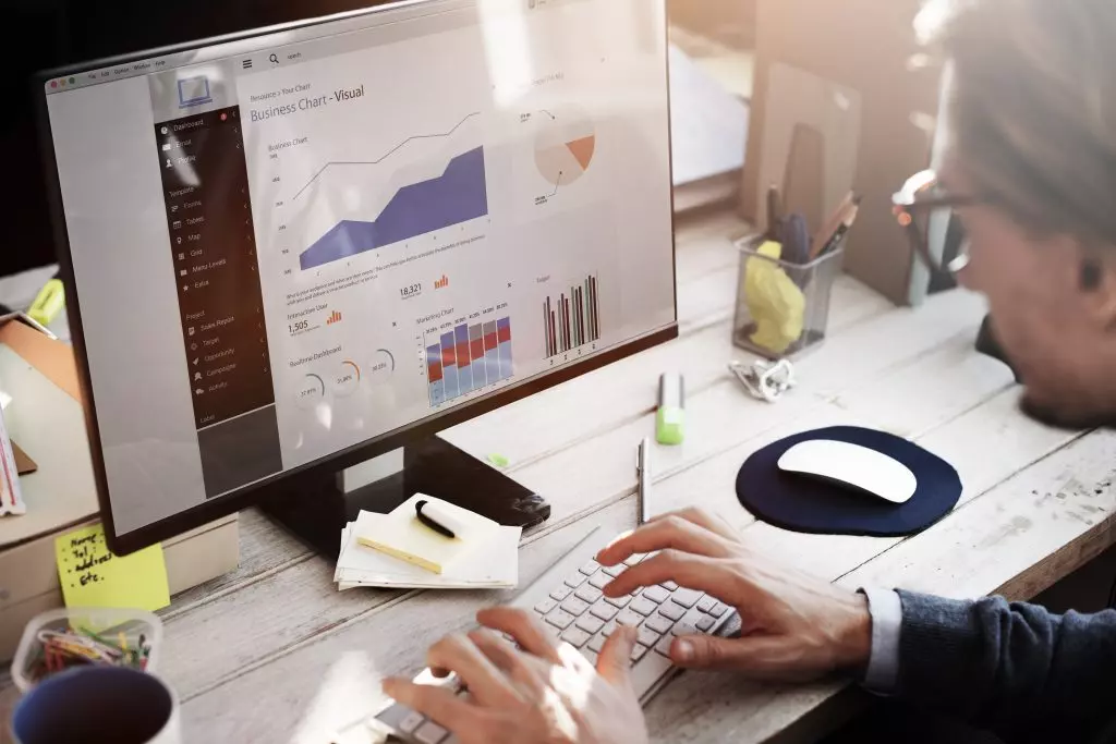 A man checking website analytics on a monitor