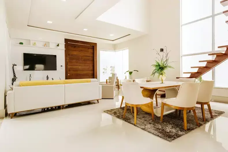 white wall, brown table + sage green sofa