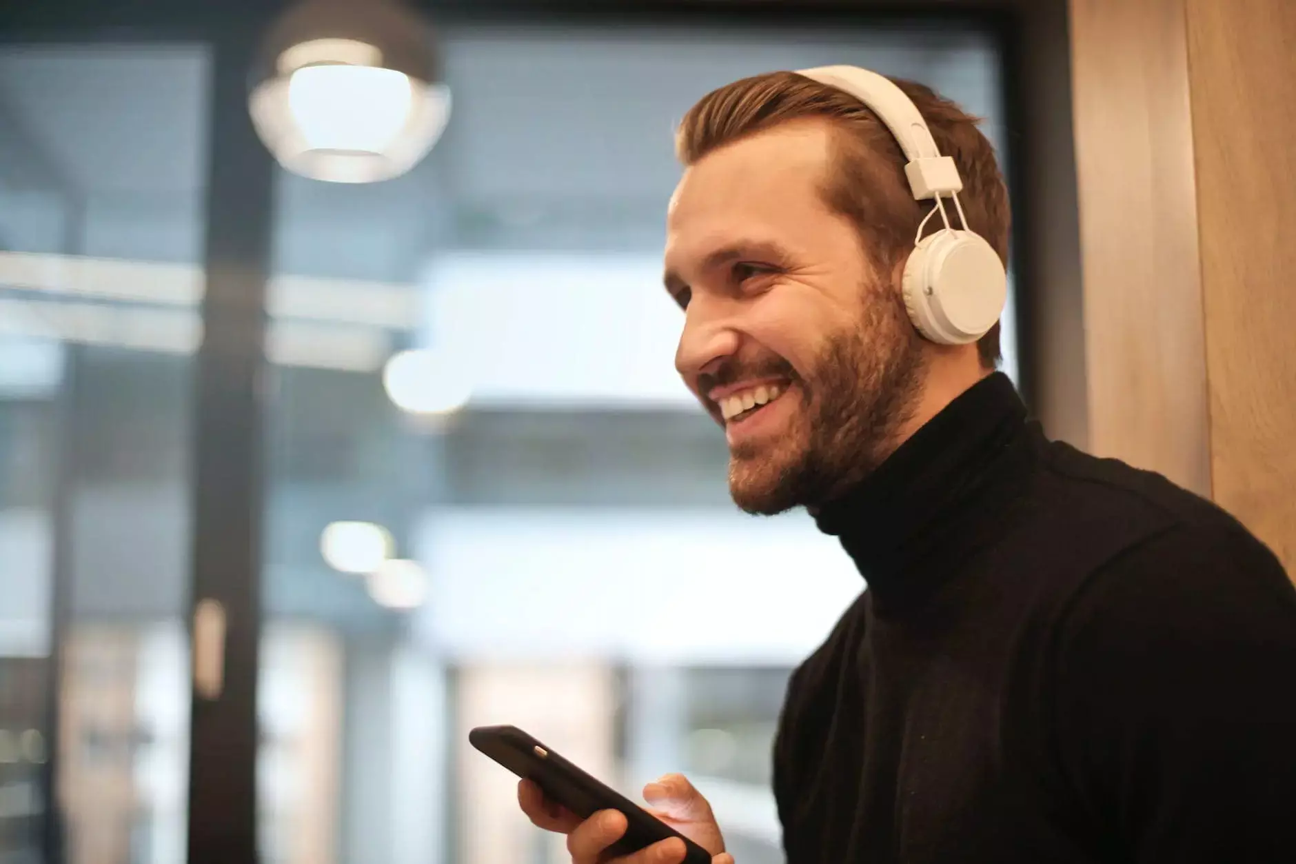 man wearing white headphones listening to music