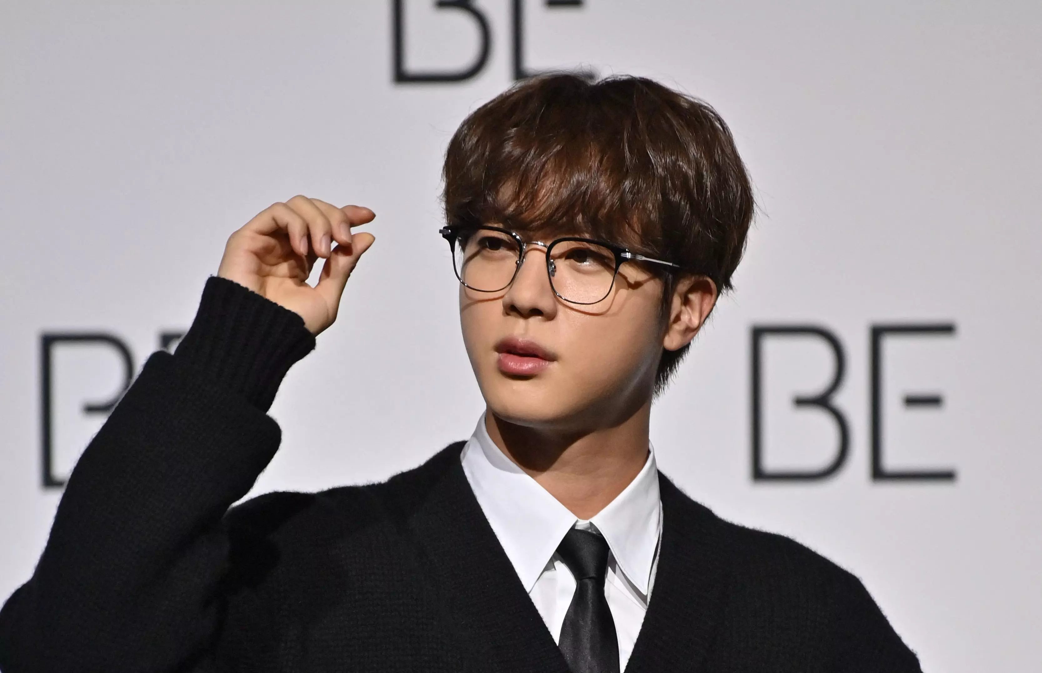 In this file photo taken on November 20, 2020 South Korean K-pop boy band BTS member Jin poses for a photo session during a press conference on BTS new album