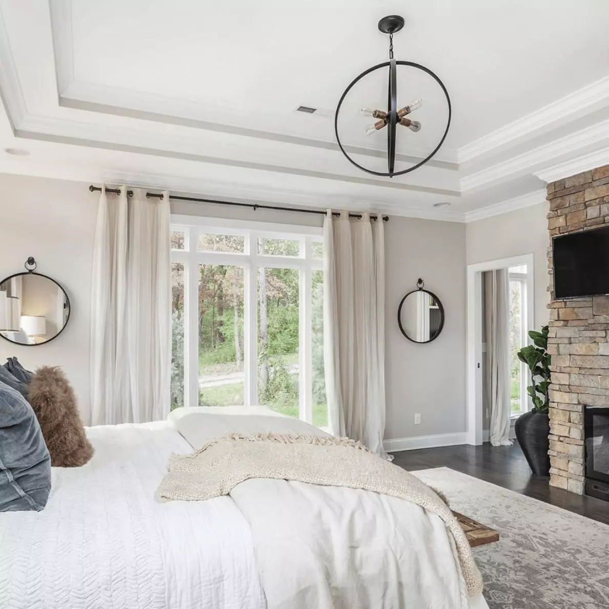 Bedroom painted SW Agreeable Gray with white bedding and blue accents