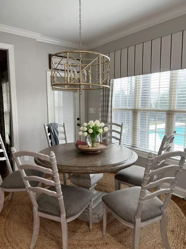 Kitchen with wood cabinets painted warm white, Sherwin Williams Alabaster, black granite countertop, wood floor, dining area. Kylie M Interiors Edesign, Jenna Christian's home