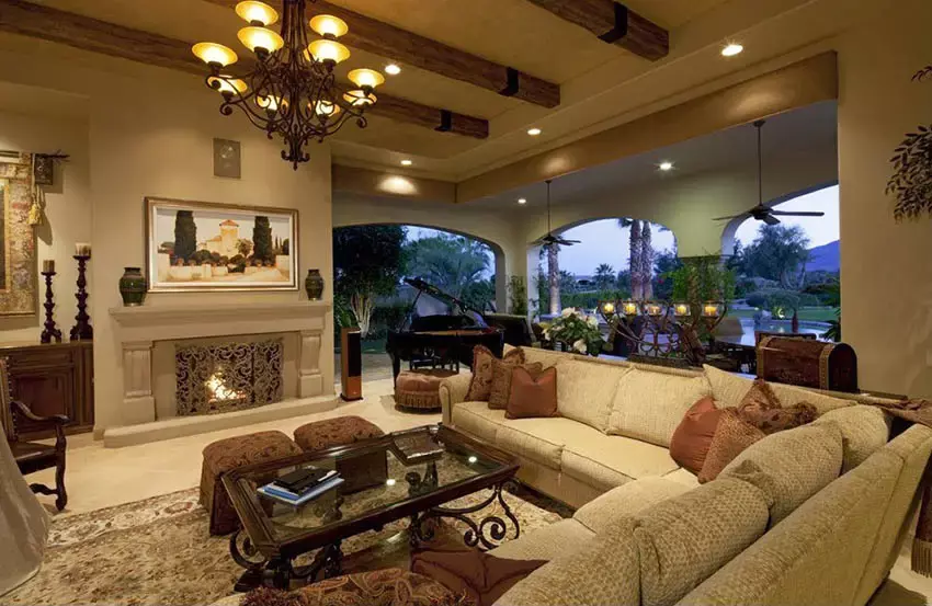 Earth-colored living space with high ceilings fireplace and concrete floors