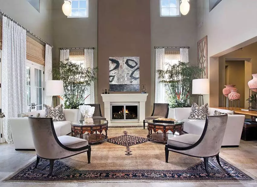 Room with high vaulted ceiling and stone fireplace