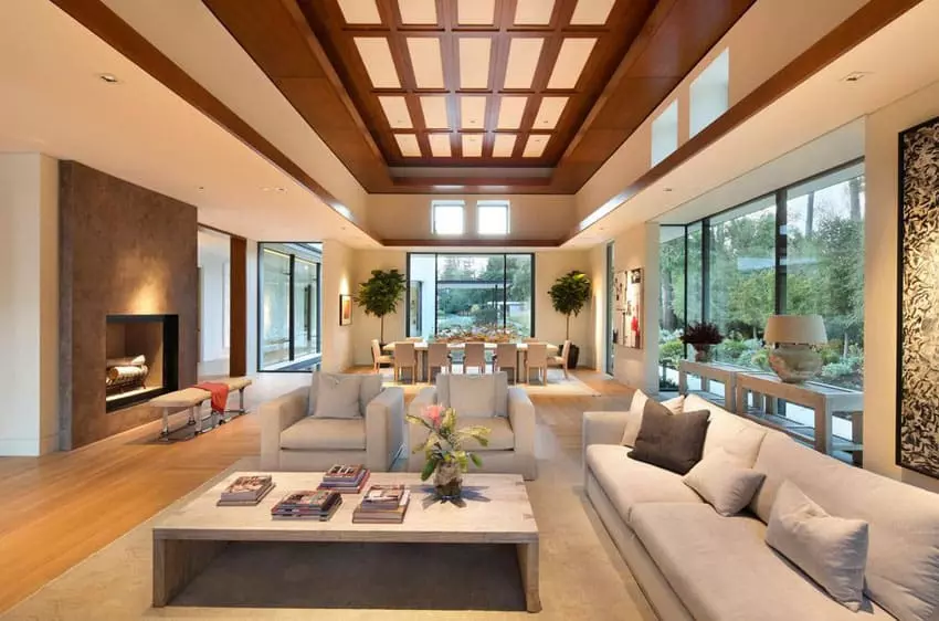 Room with fireplace and rough wood ceiling beams