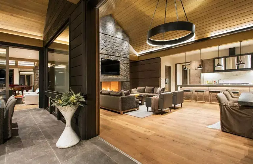 Luxury room with tan paint white wainscoting fireplace and chandelier