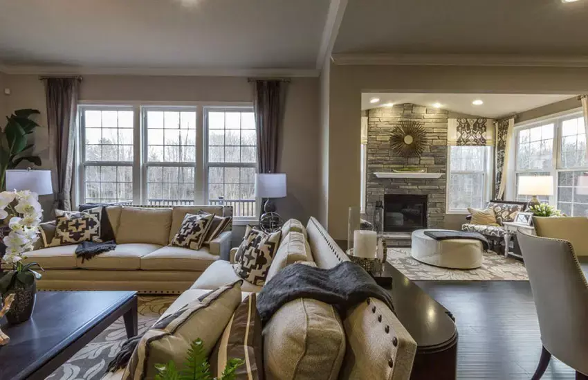 Beige room with stacked stone accent wall and fireplace