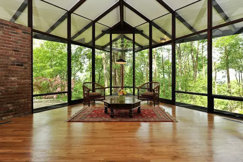 Room with sloped ceiling bamboo flooring and lamp