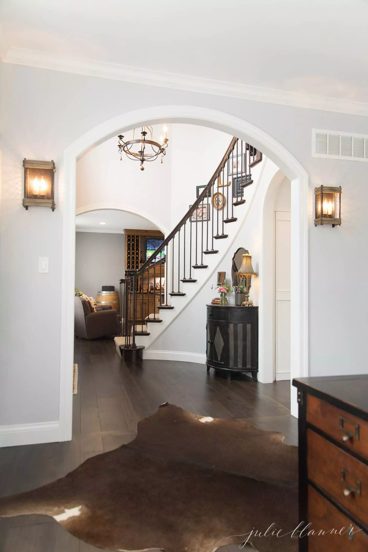 modern colonial staircase and arched opening